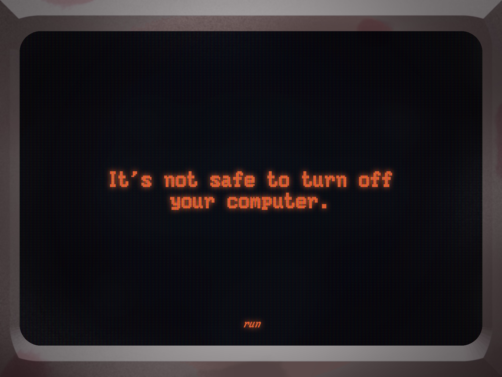 CRT monitor displaying the text 'It's not safe to turn off your computer.' At the bottom in smaller text it says 'run'. The monitor bezel is slightly stained by crimson.